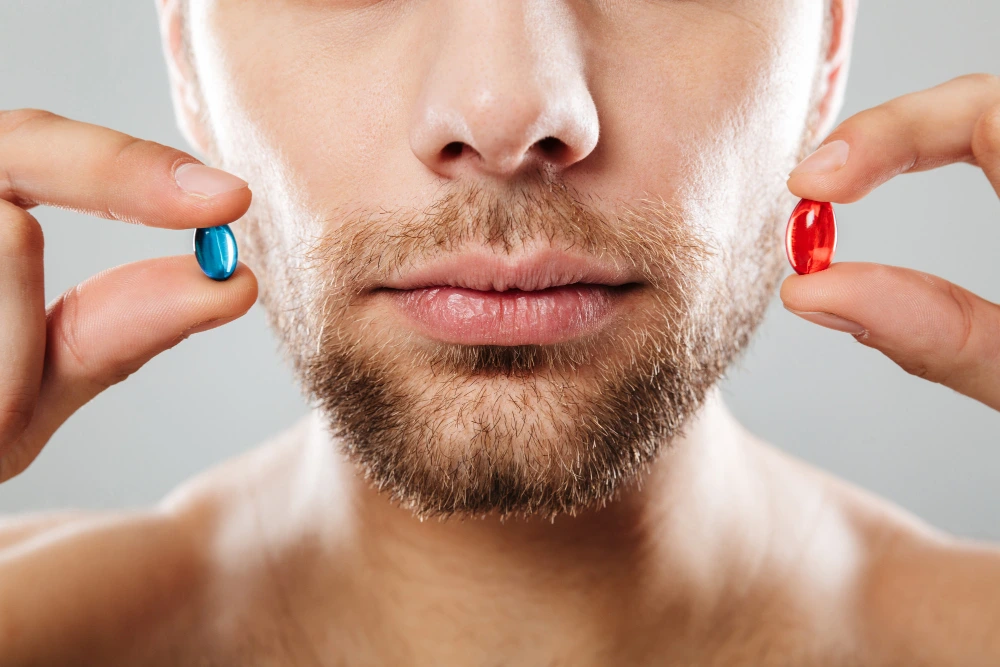 finasteride vs dutasteride — man holding two different pills, deciding between treatments