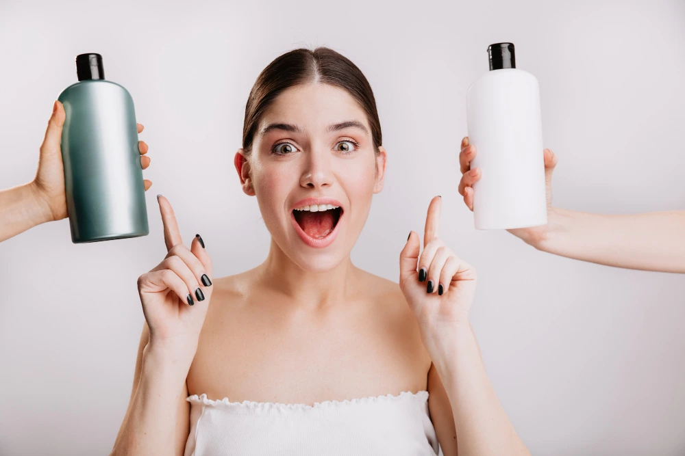 Happy woman found the best shampoo for thinning hair, holding two suitable options