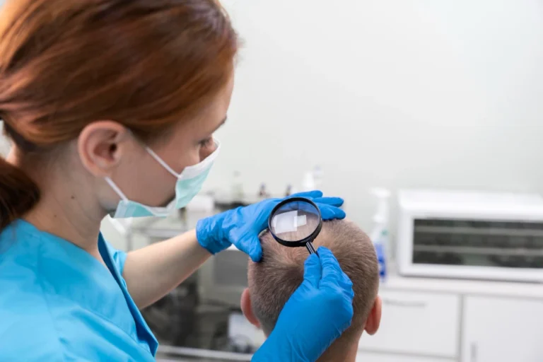 Female hair transplant surgeon examining a patient's scalp during a post-op checkup and discussing procedure duration
